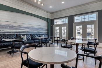 A dining room with tables and chairs and a wall mural
